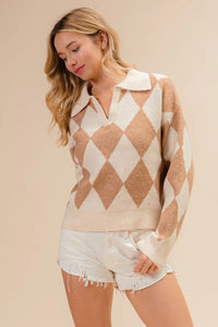 Woman wearing a diamond patterned sweater and white shorts on a beige background