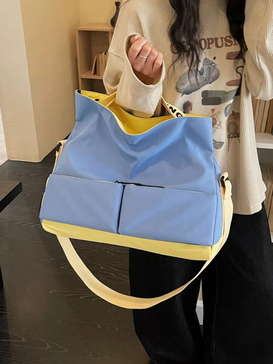 Person holding a blue and yellow bag indoors