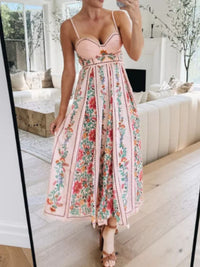 Person wearing a floral dress taking a mirror selfie in a bright living room.