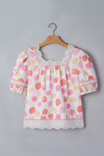 Floral blouse on a hanger against a gray background