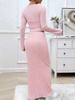 Person wearing a pink and white striped dress in a room with a white dresser.
