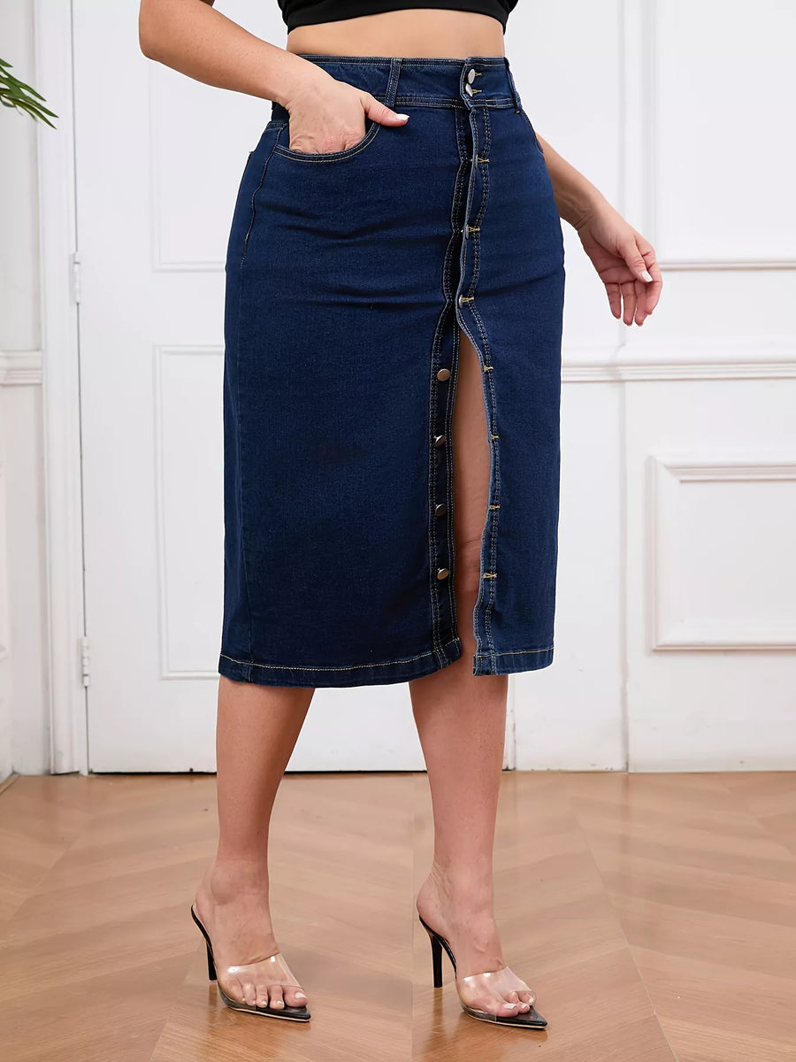 Person wearing a blue denim skirt with a button front design on a wooden floor.
