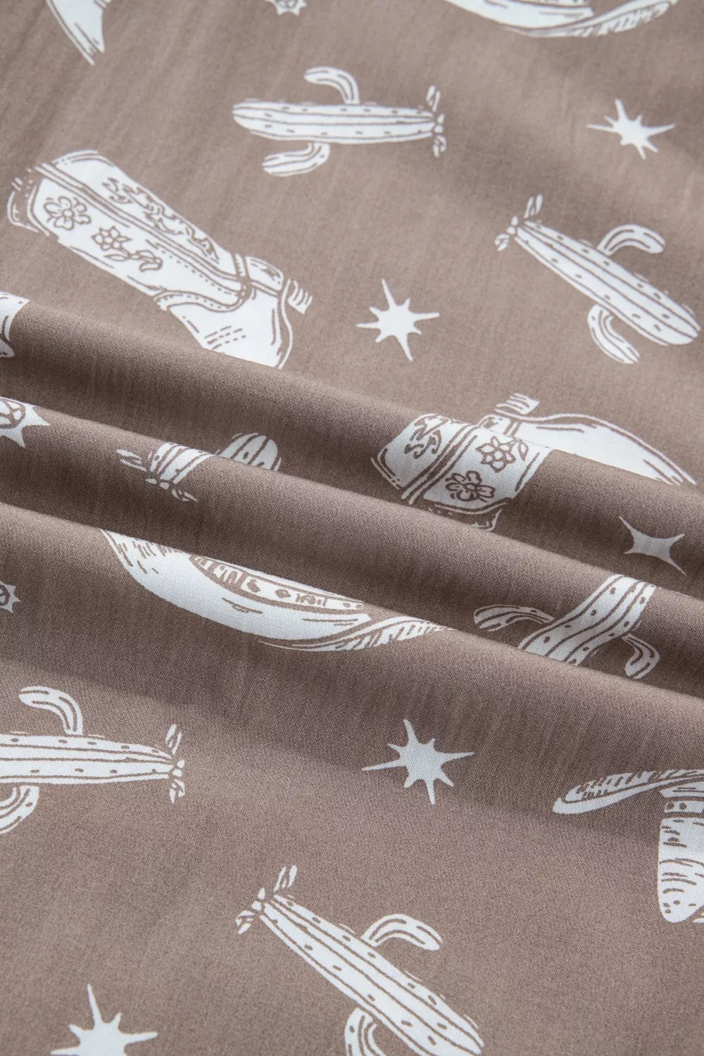 Brown fabric with white cactus and star pattern