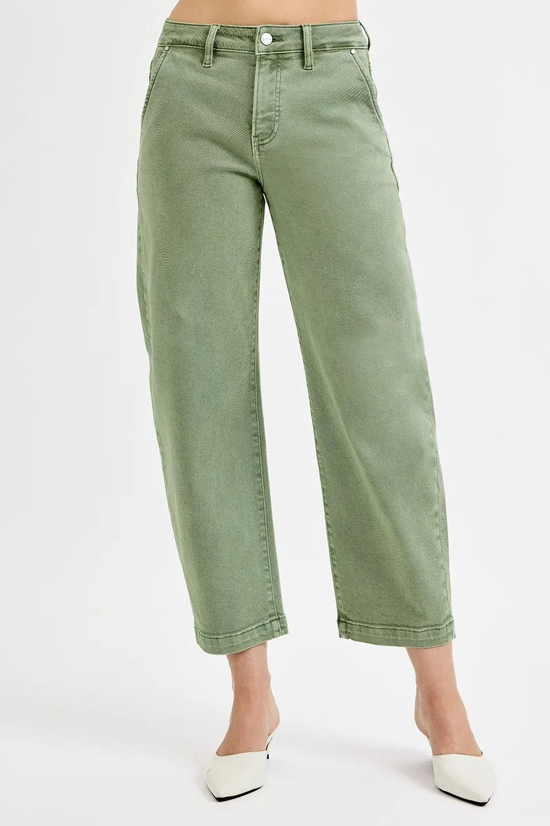 Green jeans worn by a person on a white background