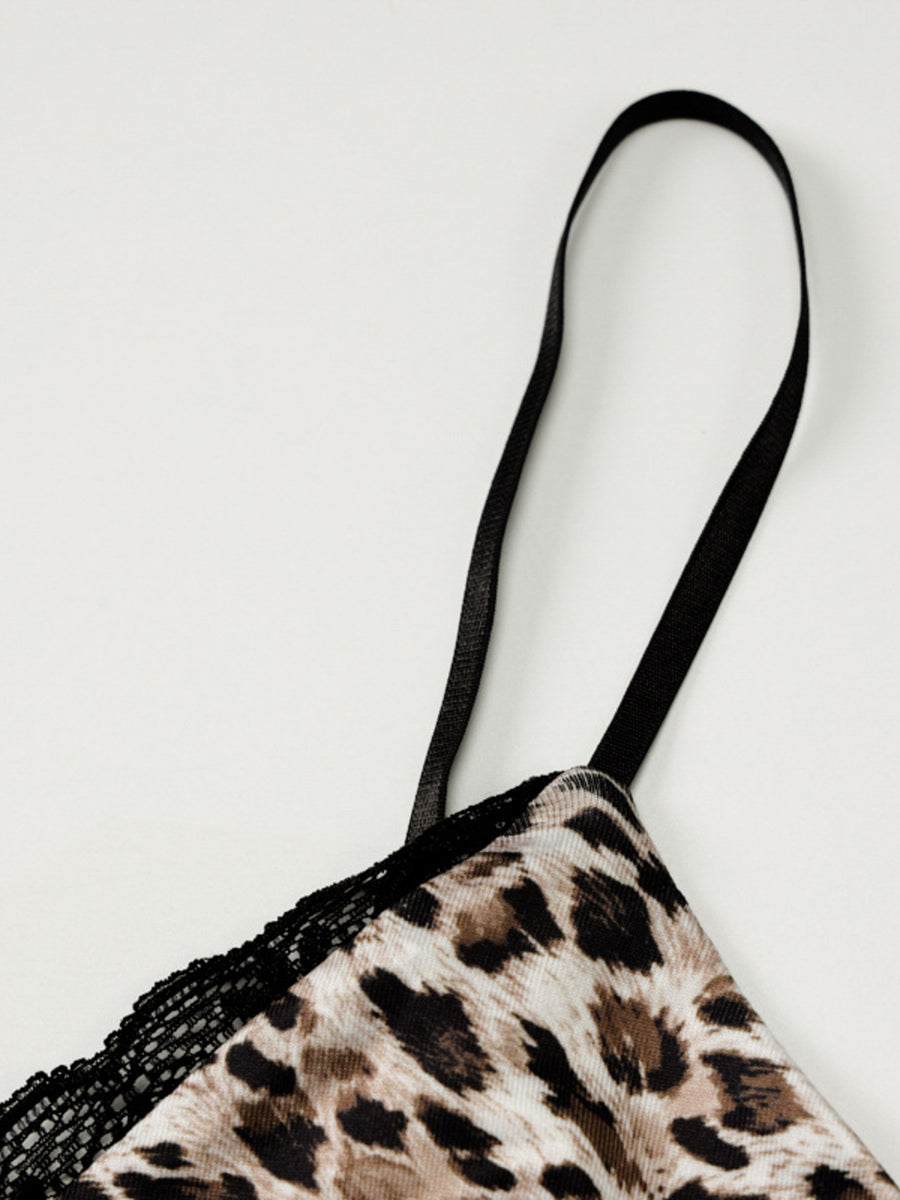 Leopard print lingerie with black lace trim on a light gray background