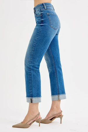 Blue jeans worn by a person on a white background
