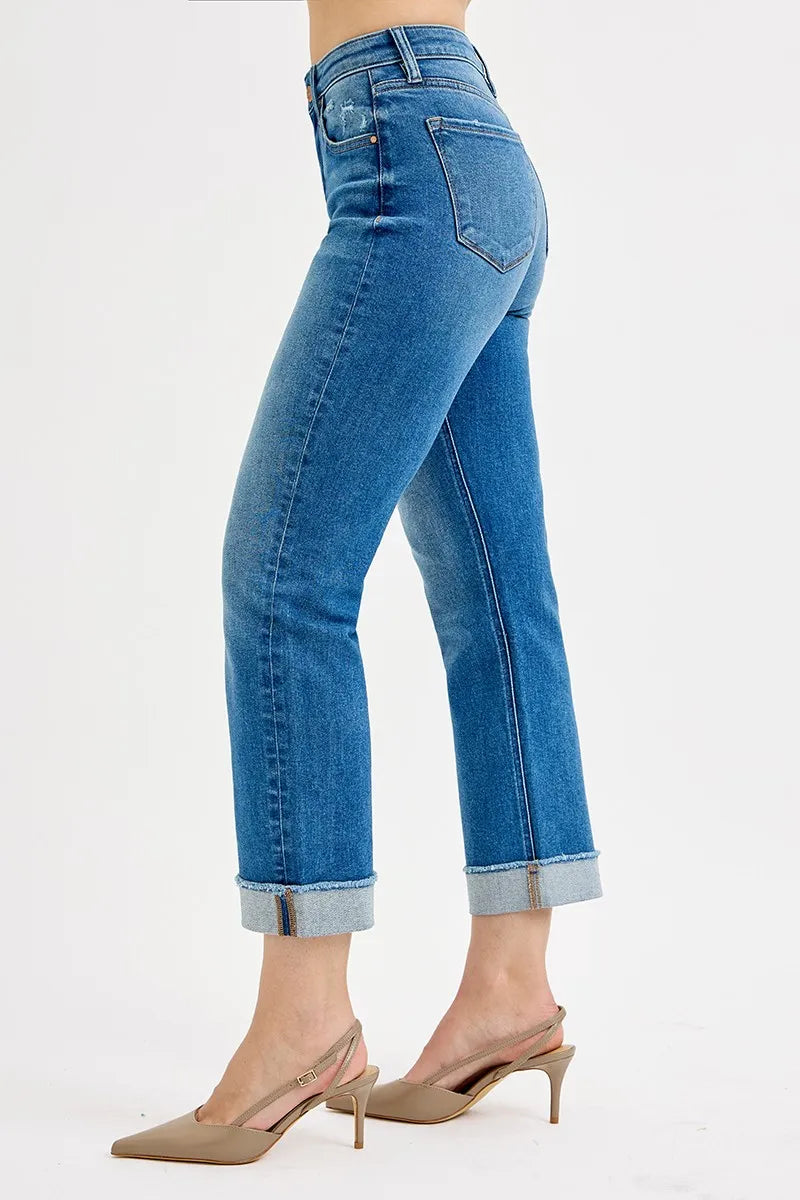 Blue jeans worn by a person on a white background