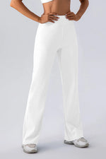Person wearing white wide-leg pants on a plain background
