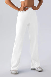 Person wearing white wide-leg pants on a plain background