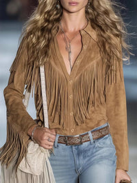 Woman wearing a brown suede fringe jacket with a blurred background