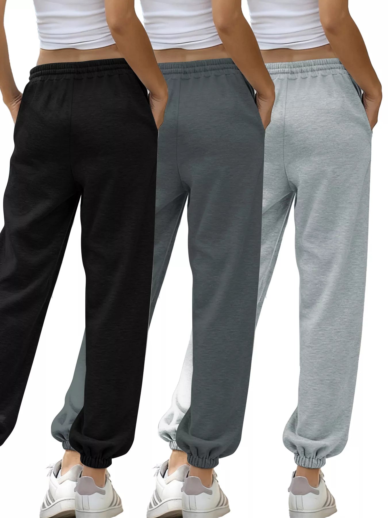 Three pairs of sweatpants in black, gray, and gray with a white background