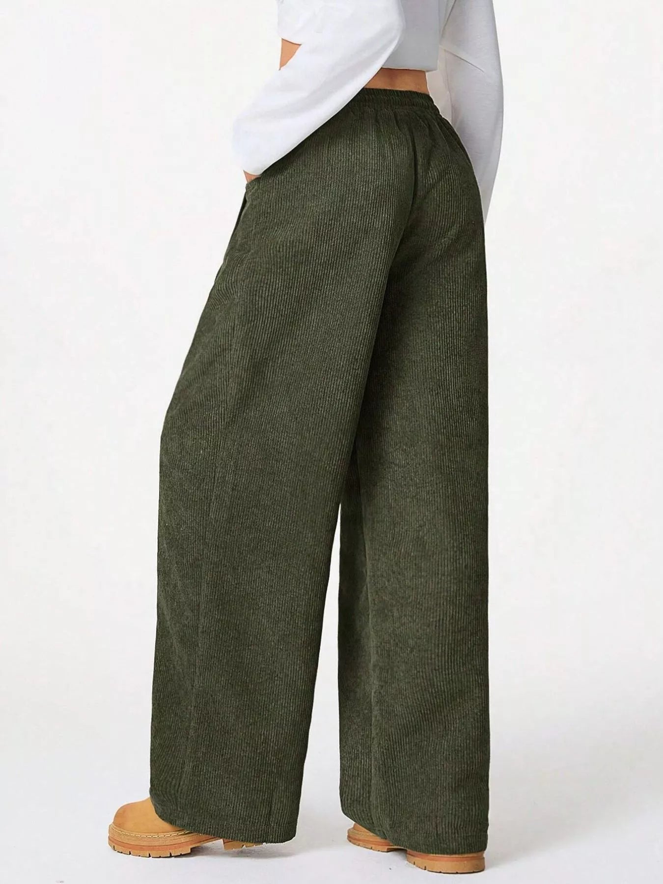 Green wide-leg pants worn by a person on a white background