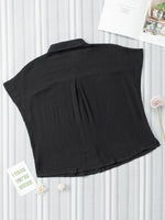 Black sleeveless top on a white background with decorative elements.