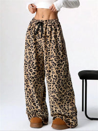 Leopard print pants worn by a person on a white background