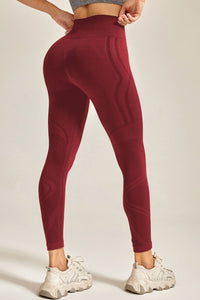 Maroon leggings worn by a person on a plain background
