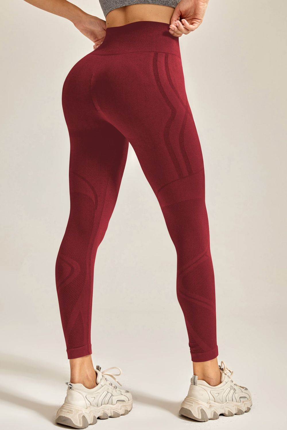 Maroon leggings worn by a person on a plain background