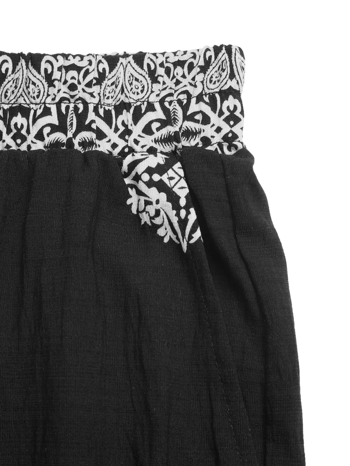 Black skirt with white paisley patterned waistband on a white background