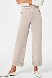 Beige wide-leg pants worn by a person on a white background