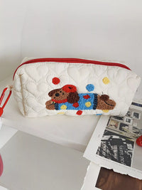 White pouch with a colorful dog design on a white surface