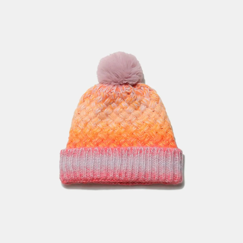 Knitted beanie with gradient color pattern on a white background