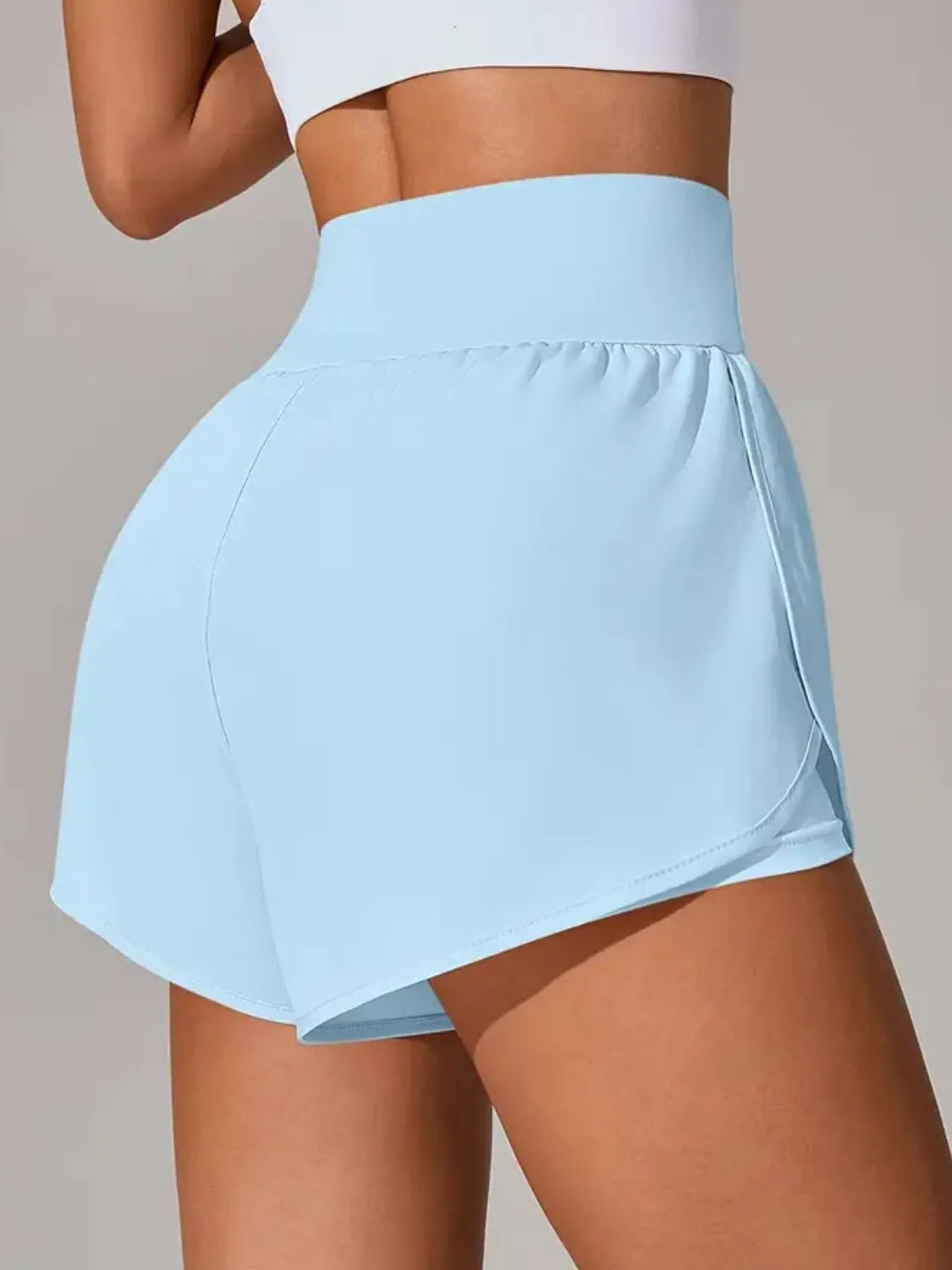 Light blue athletic skirt worn by a person on a neutral background