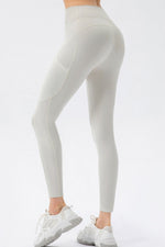 Light gray leggings worn by a person on a white background