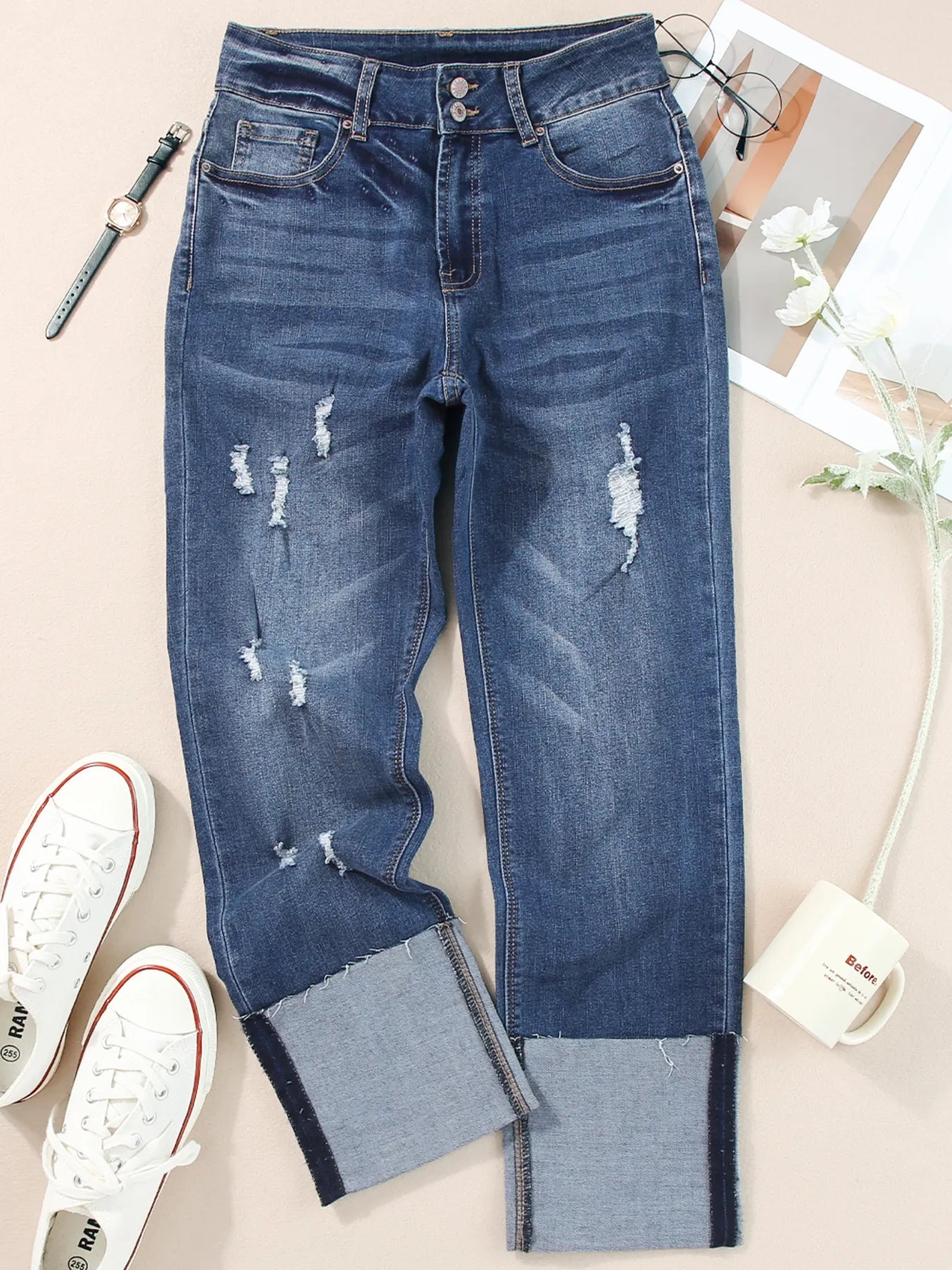 Distressed blue jeans with patchwork design on a light background