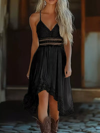 Woman wearing a black dress with intricate detailing in a blurred indoor setting