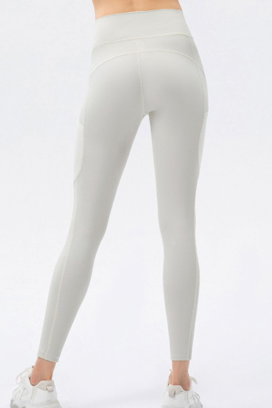 Light gray leggings worn by a person on a white background