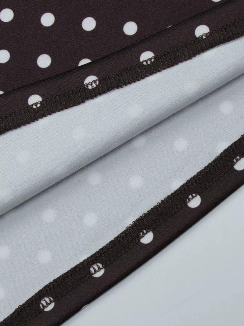 Close-up of black polka dot trim on light gray fabric background