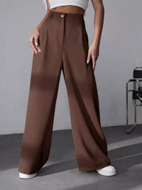 Brown wide-leg pants worn by a person on a gray background