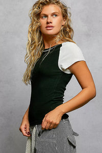 Woman wearing a black and white top with a gray background