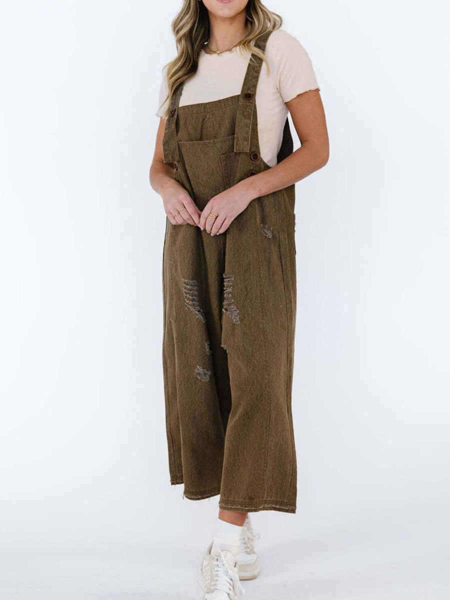 Person wearing brown overalls on a white background