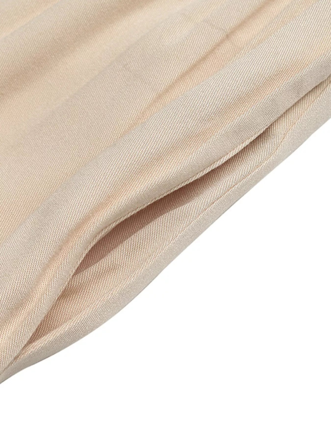 Close-up of beige fabric with a soft texture on a white background