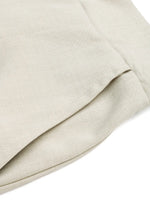 Close-up of beige fabric with a subtle texture on a white background