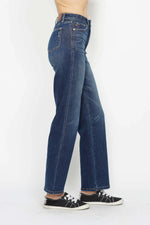 Blue jeans worn by a person on a white background