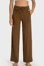 Brown wide-leg pants worn by a person on a white background