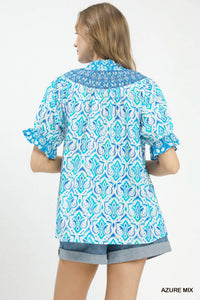 Woman wearing a blue and white patterned shirt on a white background