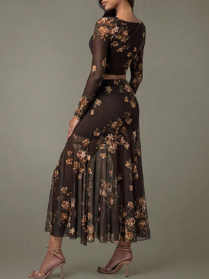 Woman wearing a dark floral dress against a gray background