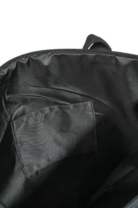 Close-up of a black bag with a pocket on a white background