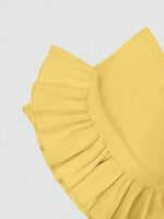 Yellow ruffled fabric on a light gray background