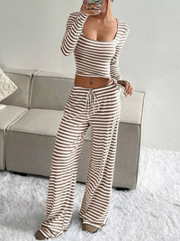 Person wearing a striped outfit in a living room setting