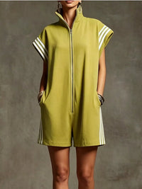 Person wearing a green sleeveless dress with white stripes on a gray background
