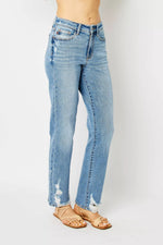 Light blue jeans worn by a person on a white background