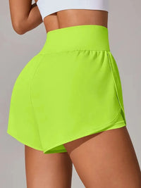 Bright green athletic shorts worn by a person on a plain background