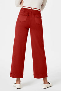Red pants worn by a person on a white background