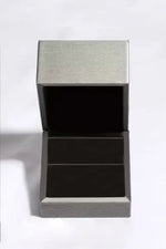Silver jewelry box with a textured lid on a white background