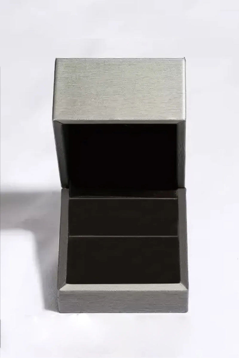 Silver jewelry box with a textured lid on a white background