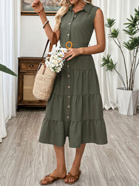 Woman wearing a green dress holding flowers indoors.