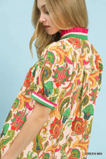 Woman wearing a colorful patterned shirt with a blue background